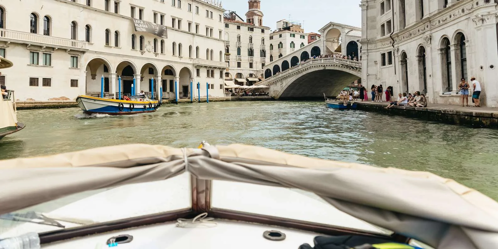 Boat ride along Venice Grand Canal during a water taxi transfer from the airport